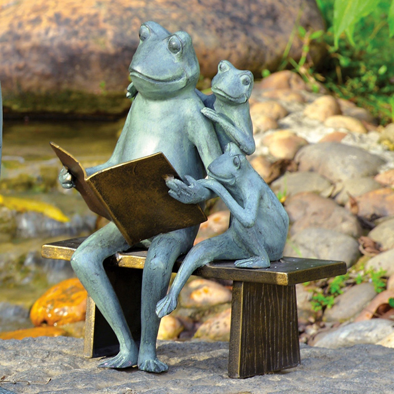 frogs reading bronze statue