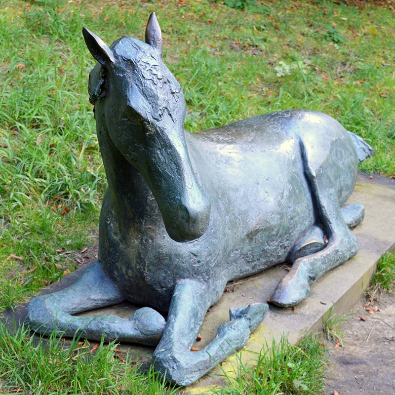 horse laying down sculpture
