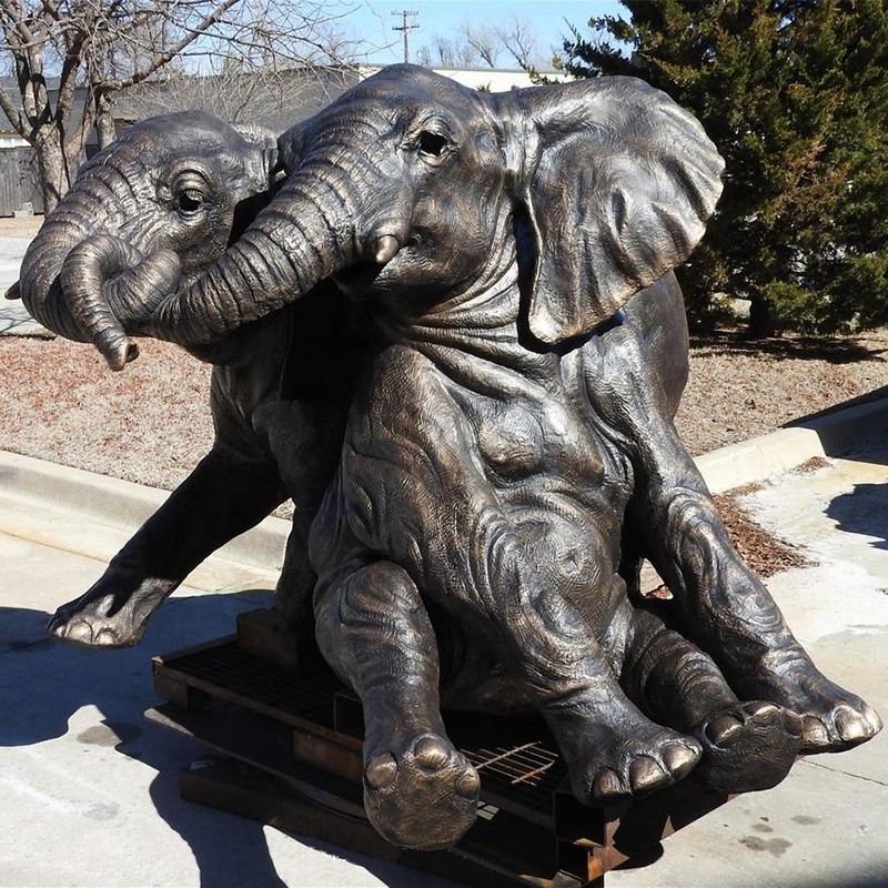 elephants sculptures noses tangled