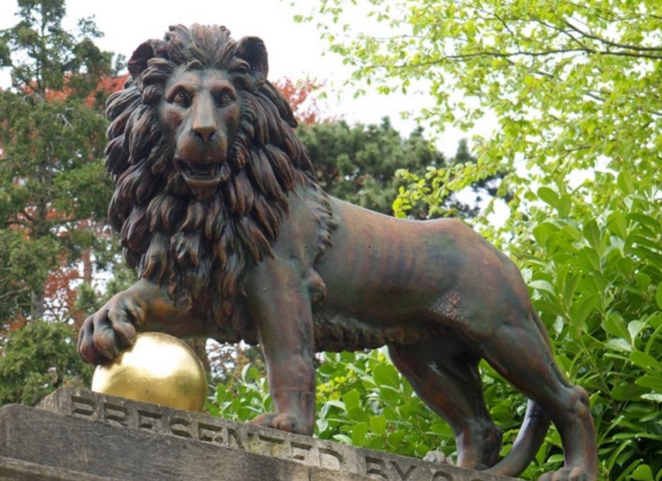 bronze lion with ball sculpture