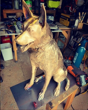 bronze sitting dog sculpture