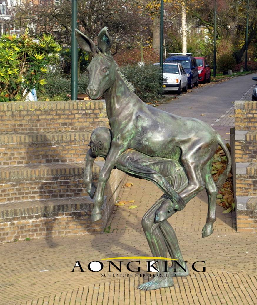 bronze sculpture of a man carrying a donkey