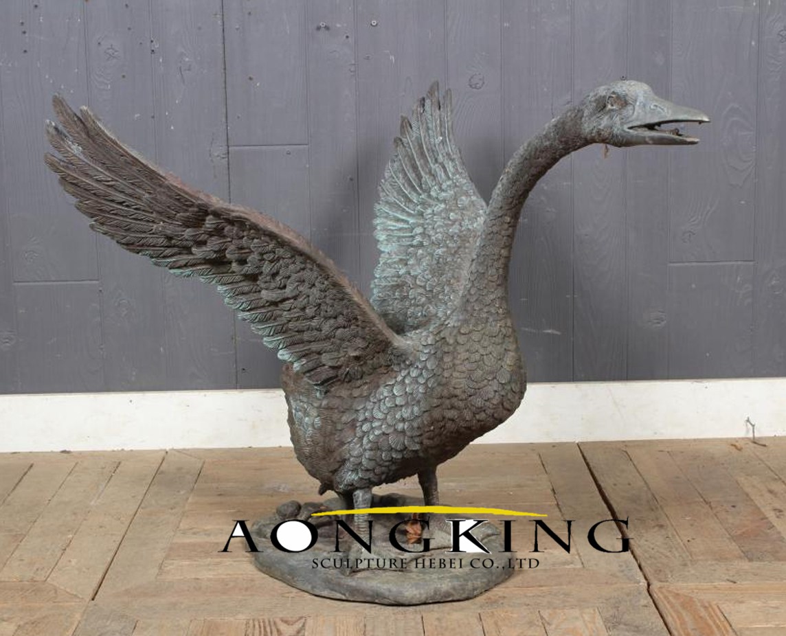 large bronze open wings goose sculpture